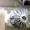 Workpiece mounted on a rotary axis inside a CNC machining center