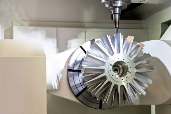 Workpiece mounted on a rotary axis inside a CNC machining center
