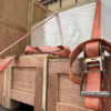 Wooden crates secured with straps inside a vehicle