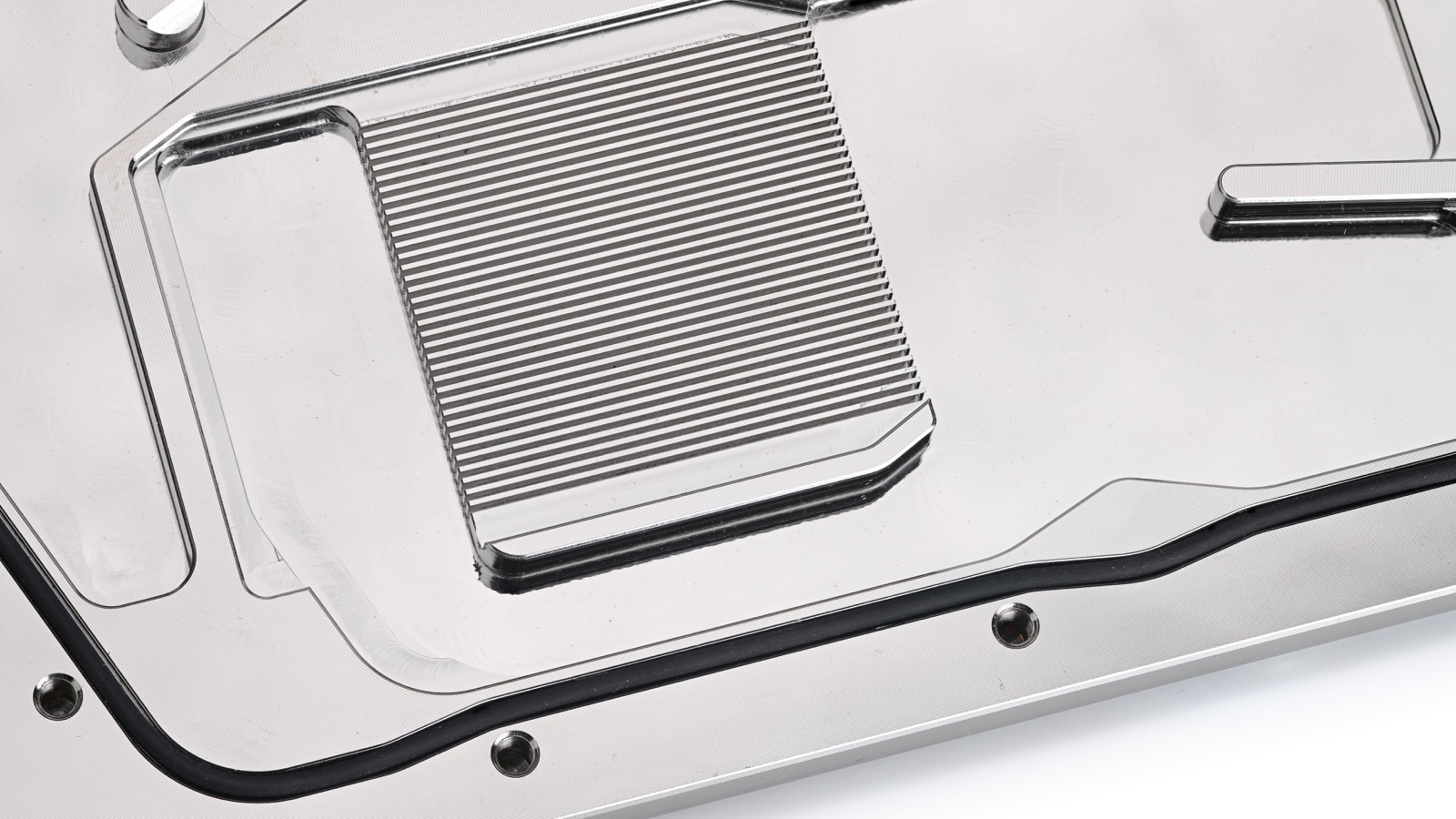 Opened gasket-sealed GPU water block showing machined microchannels and the sealing boundary