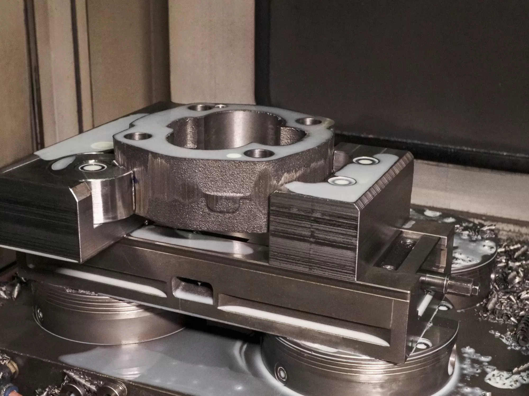 A workpiece in a fixture mounted on zero-point modules inside a machining center