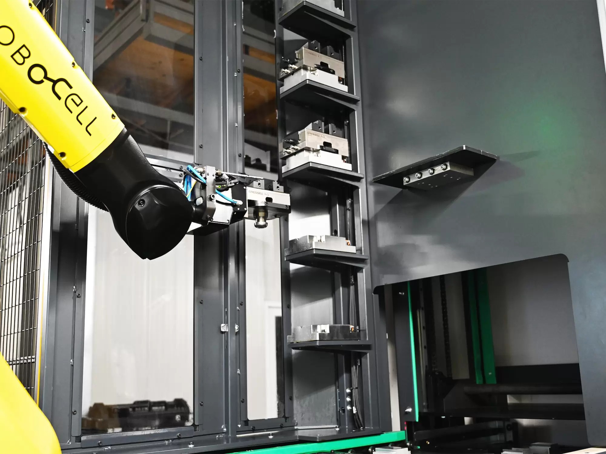 A storage rack in a robot-loaded cell, with prepared vises and empty positions