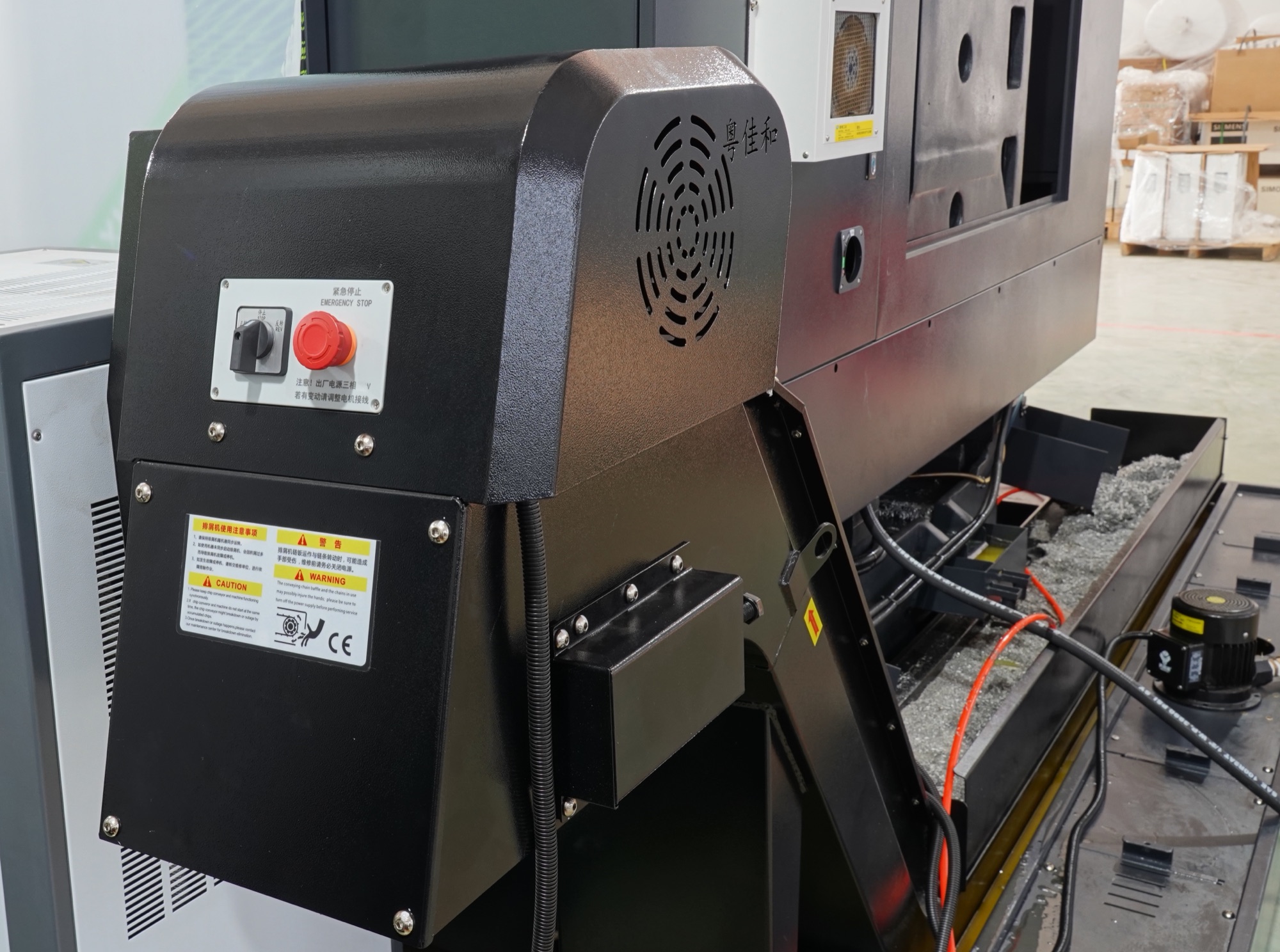 Chip conveyor and coolant unit fitted to a CHANSIN machining center on the shop floor