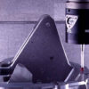 A spindle-mounted probe measuring a metal workpiece inside a machining center