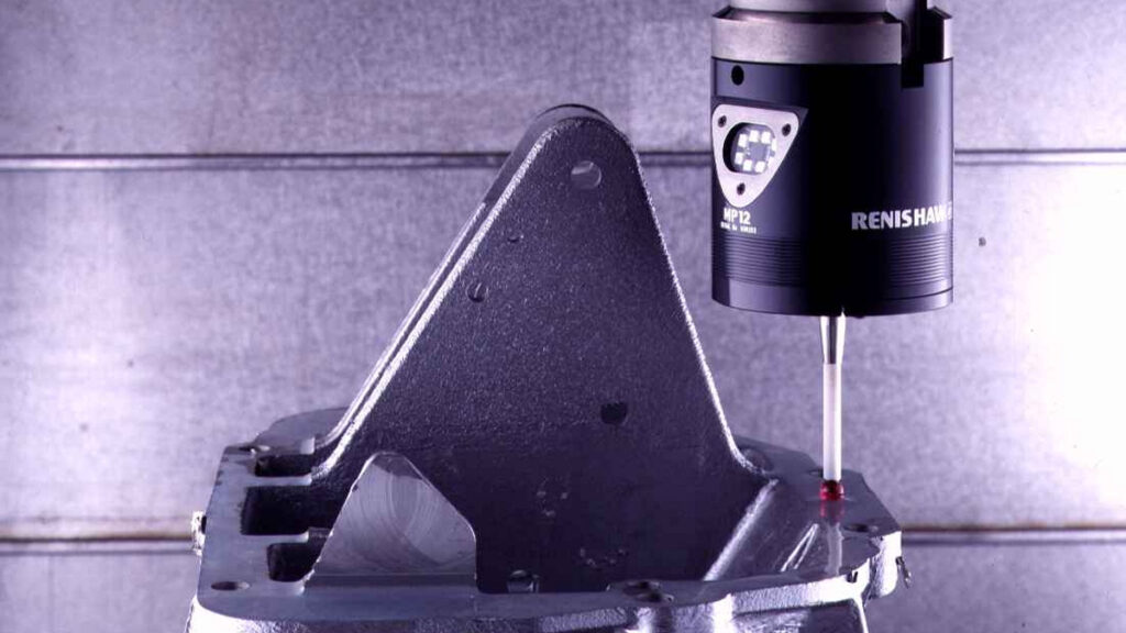 A spindle-mounted probe measuring a metal workpiece inside a machining center