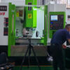 CHANSIN machining center with a tripod-mounted laser measurement head and optics at the spindle