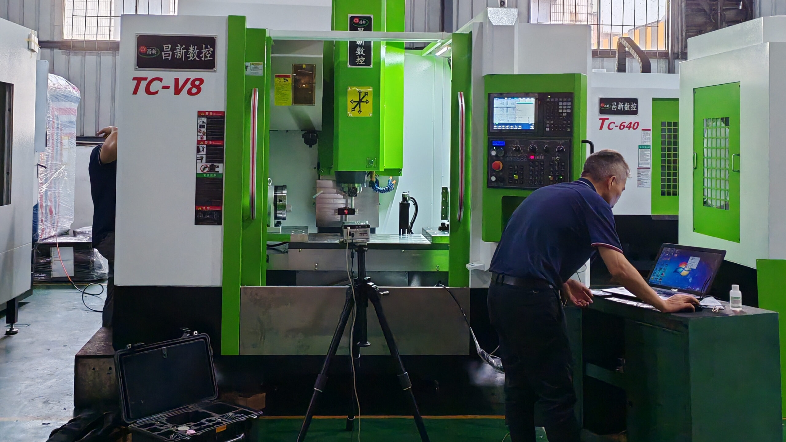 CHANSIN machining center with a tripod-mounted laser measurement head and optics at the spindle